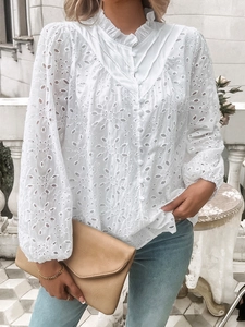 Detailed view of white lace hollowed-out puff sleeves and ruffled collar embroidery shirt