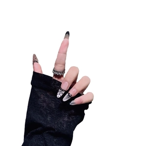 French lace press-on nails with black polka dots, bows, and silver glitter finish