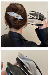 Detail of large acetate hair clips with marble pattern for elegant updo hairstyles
