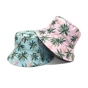 Detail of pink and blue bucket hats with tropical flamingo and palm tree prints