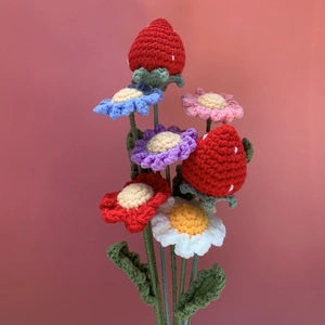 Handcrafted crochet flower bouquet featuring woolen strawberries and colorful daisies