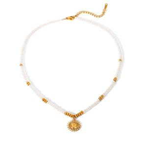 Detailed view of the sun pendant on a beaded necklace with high-quality gold hardware