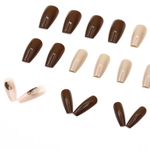 Coffin shaped press-on nails in coffee brown and beige marble texture glossy finish