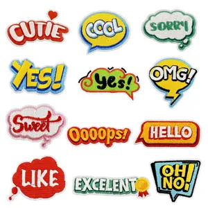 Detailed view of 12 colorful embroidered slogan patches with text like CUTIE and COOL