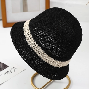 Close-up of black knitted bucket hat with beige stripe and hollow breathable design