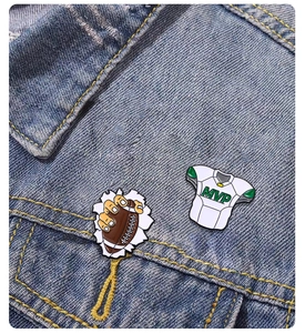 Detail of American football enamel pin set on denim jacket featuring MVP jersey and player