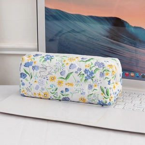 Quilted cotton makeup bag with floral bunny pattern on a laptop keyboard