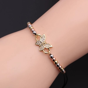 Detail of adjustable bracelet with copper zircon butterfly pendant and tri-color metal beads