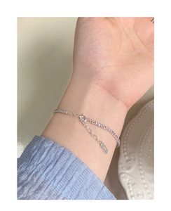Detail of S925 sterling silver tennis bracelet with pink zircon on a woman's wrist