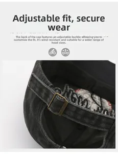 Detail of adjustable bronze metal buckle on dark grey washed cotton baseball cap