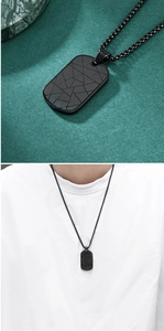 Black military style dog tag necklace with geometric patterns and on-model view