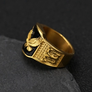 Mens hip hop gold stainless steel eagle ring with black enamel on a dark stone