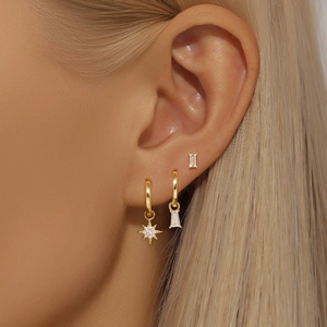 Detailed close-up of S925 silver star and rectangle zircon pendant earrings on a model