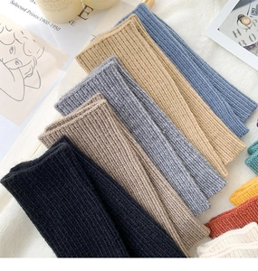 Macro shot of thick ribbed knit texture in various winter colors like grey and blue