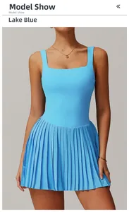 Detail of lake blue sleeveless pleated tennis dress featuring a square neck and athletic fabric