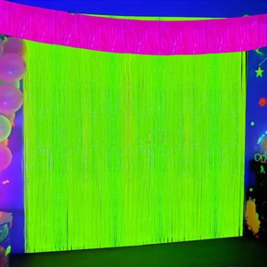Neon green fringe curtain with pink scalloped trim for neon party backdrop decoration