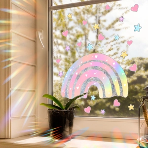 Holographic rainbow window sticker with hearts and stars casting prism light patterns