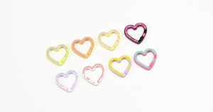 Detailed view of colorful heart-shaped alloy spring rings with polka dot patterns