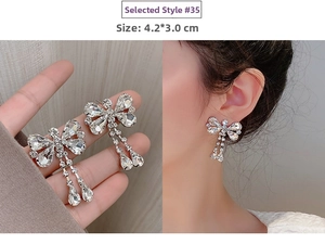 Detail of silver long tassel butterfly earrings with sparkling crystals, size 4.2x3.0cm