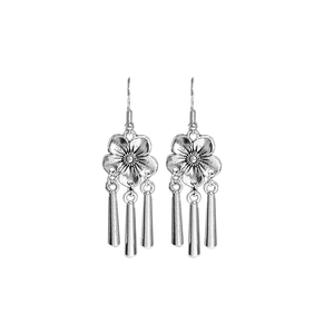 Vintage silver flower earrings with metal tassel pendants in ethnic style on white background