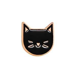 Macro detail of black enamel cat pin with golden metallic outlines and heart nose