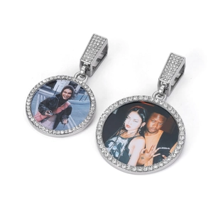 Macro detail of custom silver photo pendants with shimmering zircon pavé edges