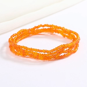 Detailed view of layered orange glass bead chain for waist or wrist styling