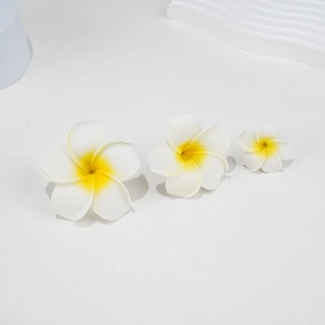 Detailed comparison of three sizes of realistic foam plumeria hair clips in white and yellow