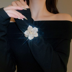Close-up of sparkling floral cuff bracelet with rhinestones on black knit fabric