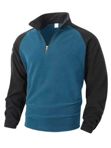 Detail of blue and black tactical fleece pullover with half-zip collar and arm pocket