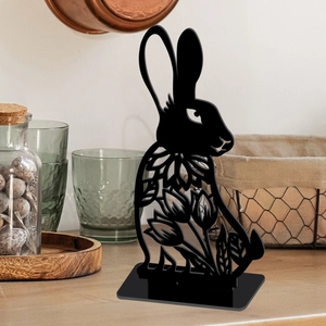 Hollow black bunny silhouette tabletop decoration with floral patterns on wood