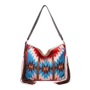 Close-up of bohemian woven tote bag showing colorful geometric patterns and long tassels