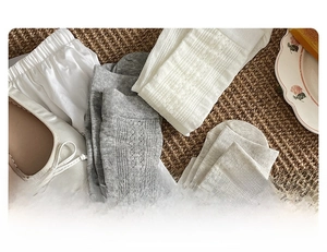 Detailed close-up of breathable cotton socks with intricate cable knit and cutout patterns