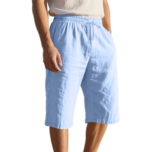 Close-up of light blue linen shorts with elastic drawstring waist and breathable fabric