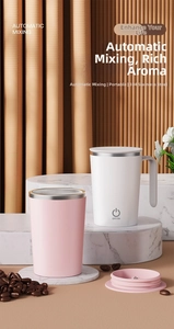 Pink and white automatic magnetic self-stirring coffee mugs on a marble display