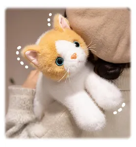 Close-up of cute realistic orange white plush cat with soft fur and blue eyes