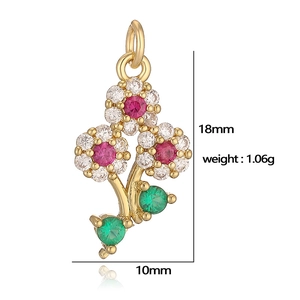 Detailed view of flower pendant with red, white and green zircon measuring 18mm by 10mm
