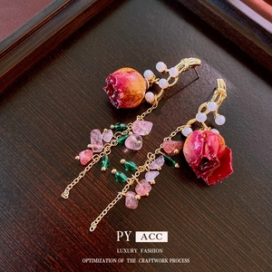 Preserved rose and pearl tassel drop earrings on vintage wooden background