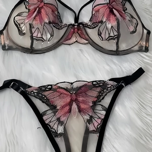 Detailed embroidery of purple butterfly lace on a black mesh lingerie set