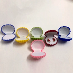 Array of colorful shell-shaped velvet jewelry boxes for rings and earrings in various colors