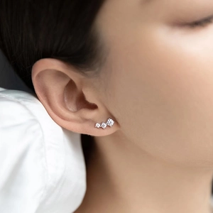 Minimalist S925 sterling silver crawler earrings with three round zircon stones on ear