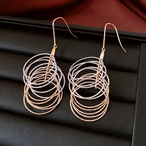 Chic multi-layered circular fringe hook earrings in gold and silver textured metal