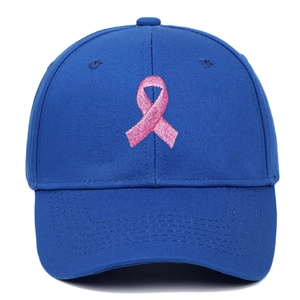 Detailed close-up of pink ribbon embroidery on navy blue structured baseball cap