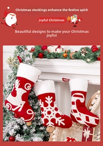 Detail of red Christmas stockings with 3D white embroidered reindeer and snowflakes