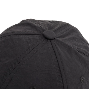 Close-up of lightweight black running hat crown with top button and stitched vent details