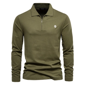 Close-up of olive green long-sleeve polo shirt with zipper collar and lion embroidery