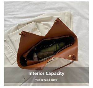 Interior view of leather tote showing large capacity with umbrella and wallet