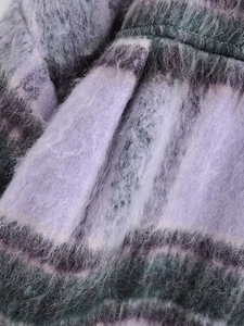 Close-up of purple and grey plaid wool coat showing fuzzy mohair fabric texture
