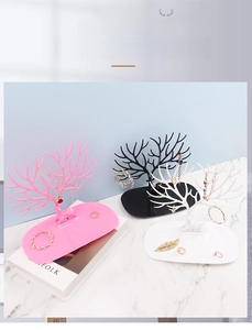 Detailed view of antler jewelry organizer in black, white, and pink with oval storage tray