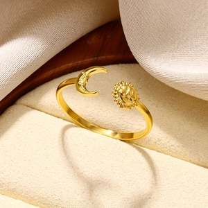 Close-up of 18K gold stainless steel open ring with sun and moon celestial charms